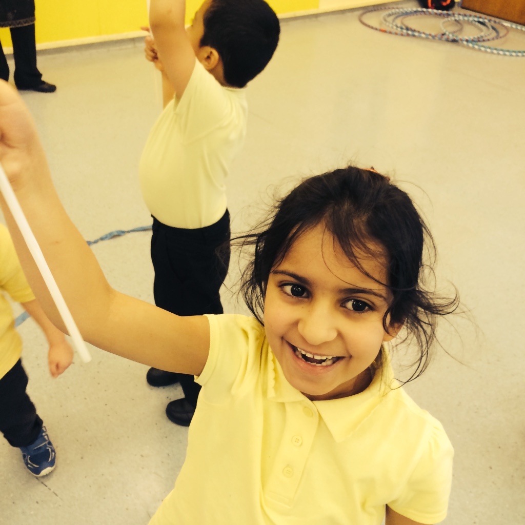 A girl learning circus skills in school